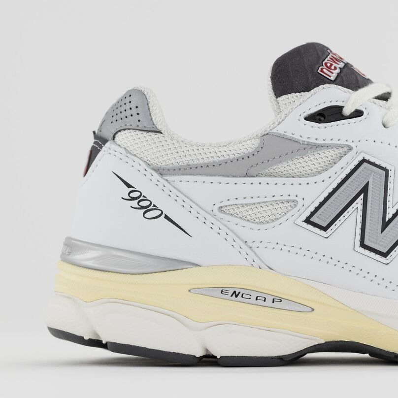Side detail of the grey 990v1 heel and materials.