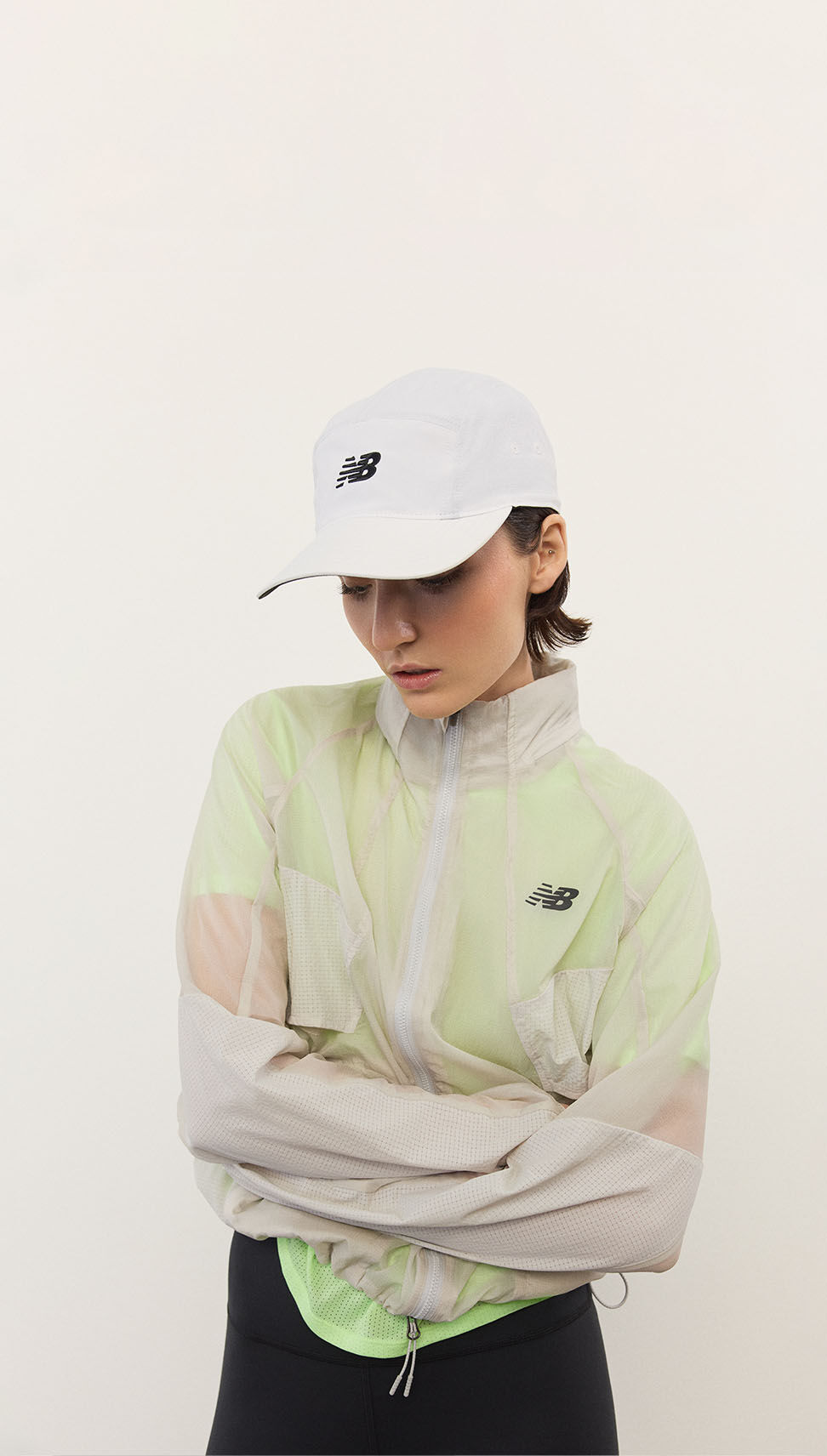 A woman standing in front of a white wall.